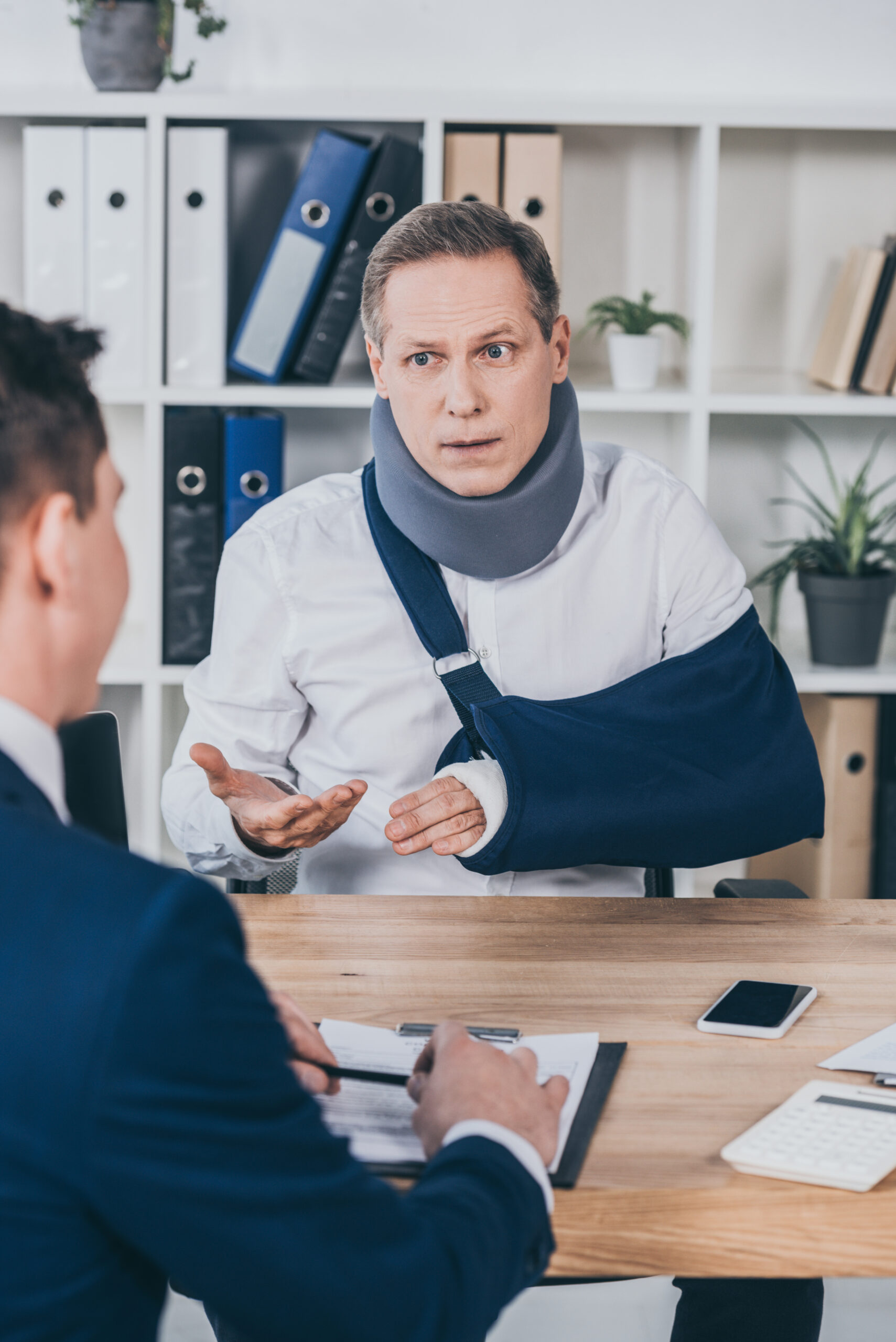 Middle Aged Worker In Neck Brace With Broken